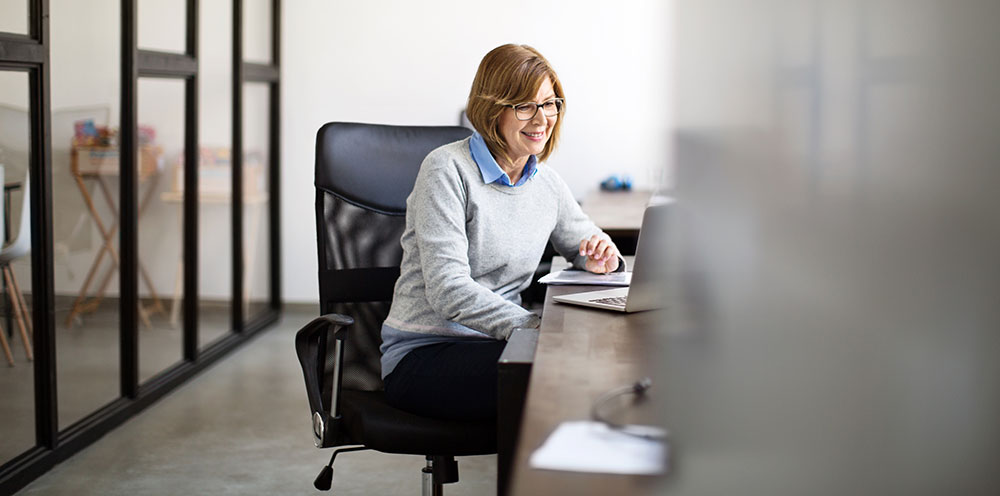 woman using computer at her desk